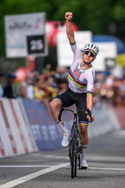 UAE Team Emirates-XRG's Slovenian rider Tadej Pogacar celebrates as he crosses the finish line to win the first stage of the Tour of Romandie UCI cycling World tour, a 171.2 km loop from Martigny-Ville to Martigny-Ville, in Martigny, on April 29, 2026. (Photo by Fabrice COFFRINI / AFP)