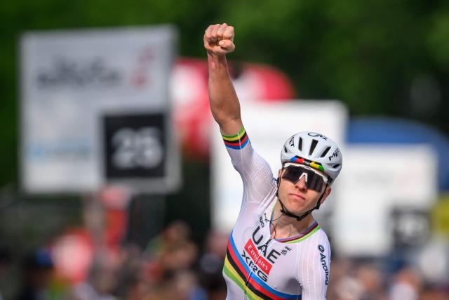 UAE Team Emirates-XRG's Slovenian rider Tadej Pogacar celebrates as he crosses the finish line to win the first stage of the Tour of Romandie UCI cycling World tour, a 171.2 km loop from Martigny-Ville to Martigny-Ville, in Martigny, on April 29, 2026. (Photo by Fabrice COFFRINI / AFP)