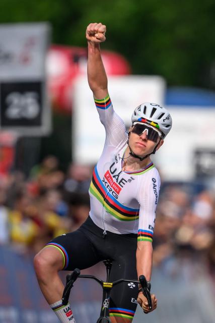 UAE Team Emirates-XRG's Slovenian rider Tadej Pogacar celebrates as he crosses the finish line to win the first stage of the Tour of Romandie UCI cycling World tour, a 171.2 km loop from Martigny-Ville to Martigny-Ville, in Martigny, on April 29, 2026. (Photo by Fabrice COFFRINI / AFP)