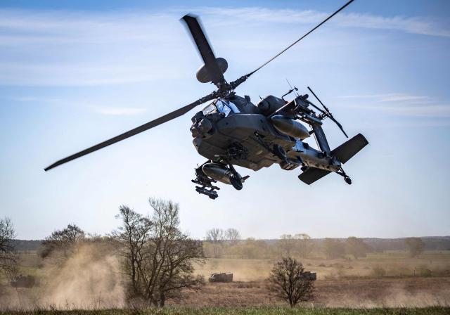 A Dutch Boeing AH-64 Apache attack helicopter takes part in a combat display during  press day for the military exercise Aurora 26 at the Revingehed training field outside Lund in Skane. The exercise at Revingehed includes personnel from several NATO countires with the focus on lessons learned from the war in Ukraine including drones. (Photo by Johan NILSSON / various sources / AFP) / Sweden OUT
