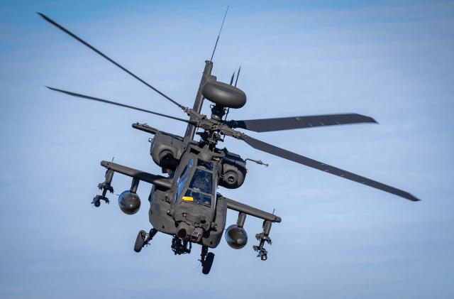 A Dutch Boeing AH-64 Apache attack helicopter takes part in a combat display during  press day for the military exercise Aurora 26 at the Revingehed training field outside Lund in Skane. The exercise at Revingehed includes personnel from several NATO countires with the focus on lessons learned from the war in Ukraine including drones. (Photo by Johan NILSSON / various sources / AFP) / Sweden OUT