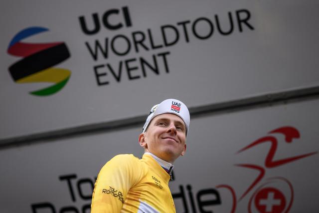 UAE Team Emirates-XRG's Slovenian rider Tadej Pogacar wearing the overall leader's yellow jersey smiles on the podium of the first stage of the Tour of Romandie UCI cycling World tour, a 171.2 km loop from Martigny-Ville to Martigny-Ville, in Martigny, on April 29, 2026. (Photo by Fabrice COFFRINI / AFP)