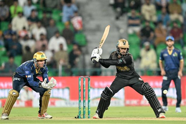 Hyderabad Kingsmen's Pakistan cricket player Usman Khan (R) plays a shot as Multan Sultans' wicketkeeper Australian cricket player Josh Philippe watches during the Pakistan Super League (PSL) Twenty20 Eliminator match between Hyderabad Kingsmen and Multan Sultans at Gaddafi Stadium in Lahore on April 29, 2026. (Photo by Arif ALI / AFP)