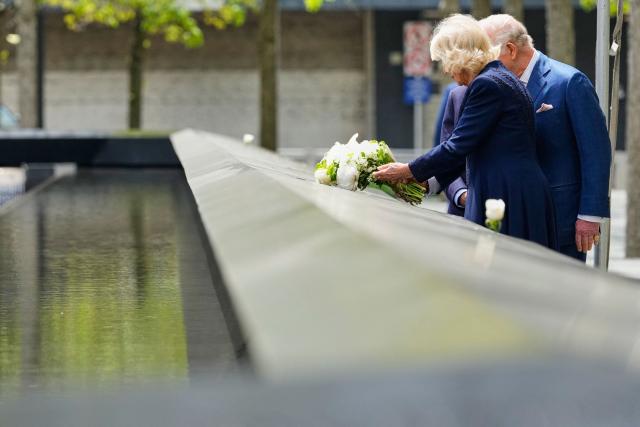 Britain's Queen Camilla lays flowers at the 9/11 Memorial during a visit with King Charles III and former New York City Mayor Michael Bloomberg on April 29, 2026 in New York. (Photo by Yuki Iwamura / POOL / AFP)