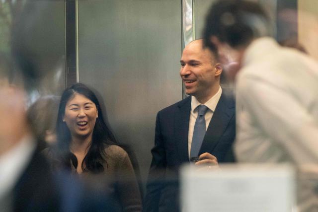 Greg Brockman, OpenAI president and co-founder, smiles while boarding an elevator as seen through a window at the Ronald V. Dellums US Courthouse in Oakland, California, during the OpenAI vs. Musk trial on April 29, 2026. Billionaire Elon Musk took the stand April 28 to accuse OpenAI and its boss Sam Altman of betraying the AI company's altruistic origins, in a trial that could have far-reaching consequences for the industry and oblige the ChatGPT maker to profoundly revamp its business. The legal clash across the bay from San Francisco is widely seen as a battle of egos pitting the world's richest person against a startup Musk once backed and now trails in the booming AI sector. (Photo by Karl Mondon / AFP)