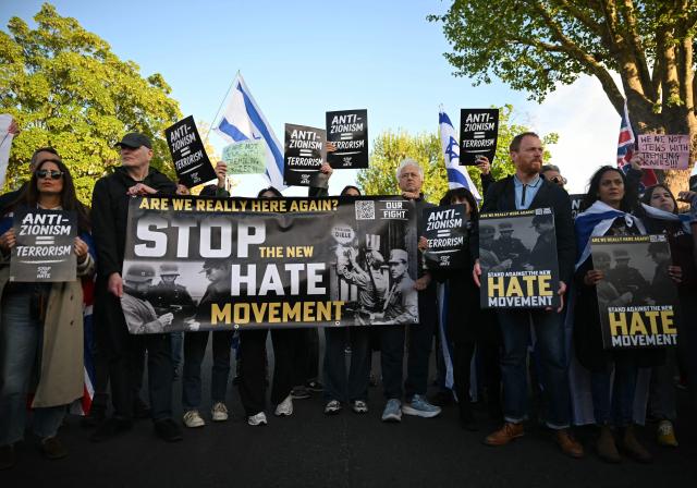 People attend a protest in the Golders Green neighbourhood of north London, on April 29, 2026, following the stabbing of two people earlier today. Two people were stabbed on April 29 in north London, Jewish groups said, following a series of arson attacks targeting Jewish sites in the area. A man was arrested after he was seen running with a knife "attempting to stab Jewish members of the public", the Shomrim Jewish neighbourhood watch said on social media. (Photo by JUSTIN TALLIS / AFP)
