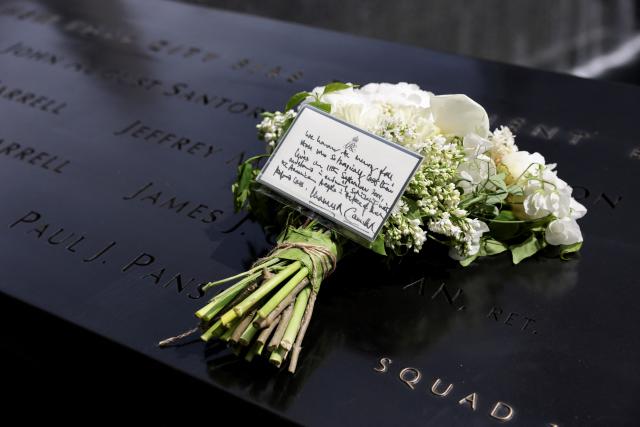 A bouquet of flowers with a note from Britain’s King Charles and Queen Camilla lies at the 9/11 Memorial, during their state visit to the United States, in New York City on April 29, 2026. (Photo by Jeenah Moon / POOL / AFP)