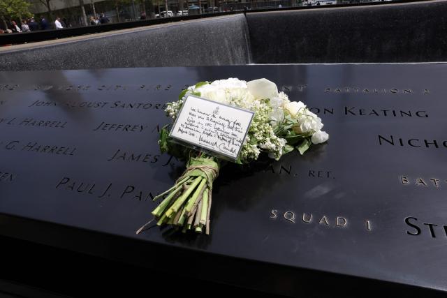 A bouquet of flowers with a note from Britain’s King Charles and Queen Camilla lies at the 9/11 Memorial, during their state visit to the United States, in New York City on April 29, 2026. (Photo by TIMOTHY A. CLARY / AFP)