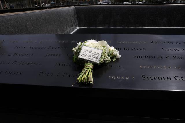 A bouquet of flowers with a note from Britain’s King Charles and Queen Camilla lies at the 9/11 Memorial, during their state visit to the United States, in New York City on April 29, 2026. (Photo by TIMOTHY A. CLARY / AFP)