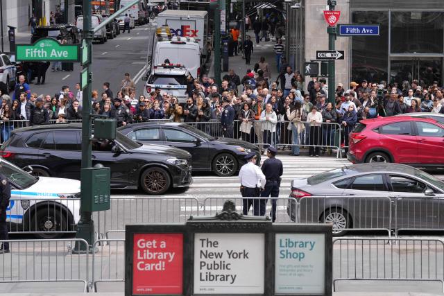 People gather on the street ahead of a visit by Britain's Queen Camilla to the New York Public Library in New York, on April 29, 2026. (Photo by Adam GRAY / AFP)