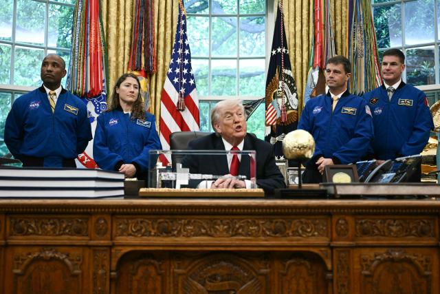 US President Donald Trump speaks as he welcomes the Artemis II astronauts, from L to R, Victor Glover, Christina Koch, Reid Wiseman and Jeremy Hansen in the Oval Office at the White House in Washington, DC, on April 29, 2026. (Photo by Brendan SMIALOWSKI / AFP)
