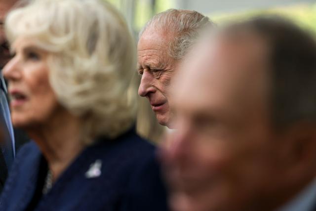 Britain's King Charles III speaks with guests as he and Queen Camilla visit the 9/11 Memorial in New York on April 29, 2026. (Photo by Jeenah Moon / POOL / AFP)