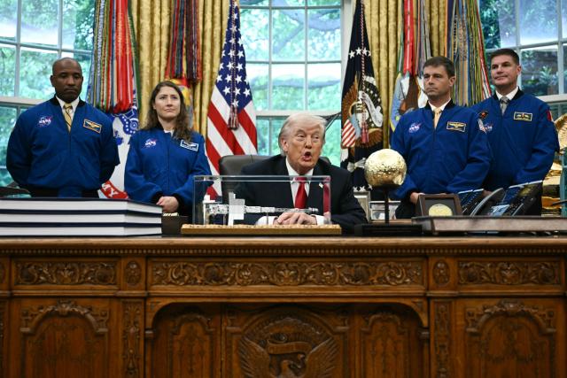US President Donald Trump speaks as he welcomes the Artemis II astronauts, from L to R, Victor Glover, Christina Koch, Reid Wiseman and Jeremy Hansen in the Oval Office at the White House in Washington, DC, on April 29, 2026. (Photo by Brendan SMIALOWSKI / AFP)