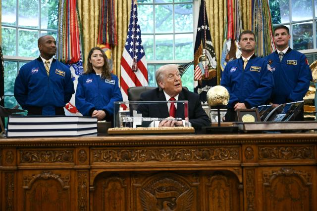 US President Donald Trump speaks as he welcomes the Artemis II astronauts, from L to R, Victor Glover, Christina Koch, Reid Wiseman and Jeremy Hansen in the Oval Office at the White House in Washington, DC, on April 29, 2026. (Photo by Brendan SMIALOWSKI / AFP)