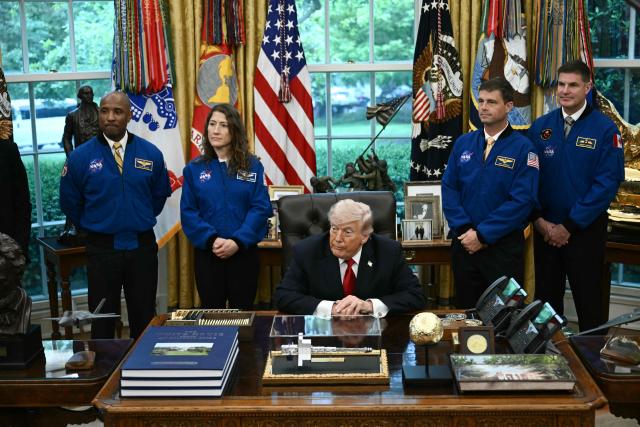US President Donald Trump speaks as he welcomes the Artemis II astronauts, from L to R, Victor Glover, Christina Koch, Reid Wiseman and Jeremy Hansen in the Oval Office at the White House in Washington, DC, on April 29, 2026. (Photo by Brendan SMIALOWSKI / AFP)