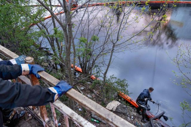 A worker cleans the river of petroleum products following a spill caused by a recent drone attack on the Tuapse oil refinery in Tuapse, Krasnodar region on April 29, 2026, amid the ongoing Russian-Ukrainian conflict. (Photo by AFP)
