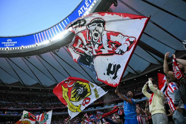 Atletico Madrid fans wave flags before the start of the UEFA Champions League semi-final first leg football match between Club Atletico de Madrid and Arsenal at the Metropolitano stadium in Madrid on April 29, 2026. (Photo by Javier SORIANO / AFP)