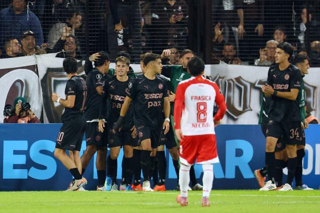 Platense's forward #09 Tomas Nasif (2nd-L) celebrates with teammates after scoring his team's first goal during the Copa Libertadores group stage football match between Argentina's Platense and Colombia's Independiente Santa Fe at the Ciudad de Vicente Lopez stadium in Vicente Lopez, Buenos Aires province, Argentina on April 29, 2026. (Photo by Alejandro PAGNI / AFP)
