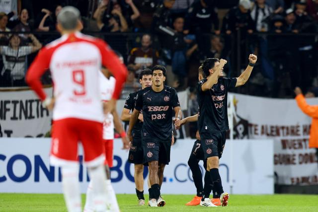 Platense's defender #34 Mateo Mendia (R) celebrates scoring his team's second goal during the Copa Libertadores group stage football match between Argentina's Platense and Colombia's Independiente Santa Fe at the Ciudad de Vicente Lopez stadium in Vicente Lopez, Buenos Aires province, Argentina on April 29, 2026. (Photo by Alejandro PAGNI / AFP)