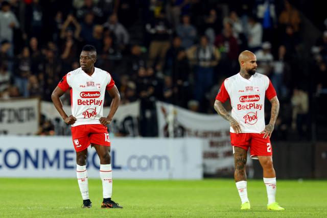 Santa Fe's defender #13 Helibelton Palacios and US defender #02 Juan Quintero react after losing the Copa Libertadores group stage football match between Argentina's Platense and Colombia's Independiente Santa Fe at the Ciudad de Vicente Lopez stadium in Vicente Lopez, Buenos Aires province, Argentina on April 29, 2026. (Photo by Alejandro PAGNI / AFP)