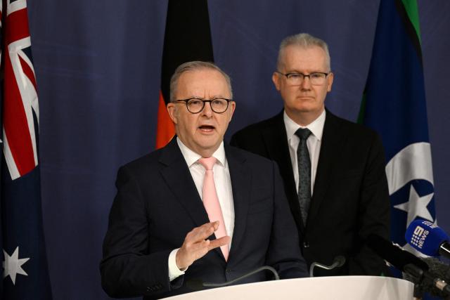 Australia's Prime Minister Anthony Albanese (L) speaks on the Royal Commission on last year's mass shooting incident where two gunmen killed 15 people at Australia's Bondi Beach, while Home Affairs Minister Tony Burke (R) looks on during a press conference in Sydney on April 30, 2026. Australia should bolster security at Jewish events and review key counter-terrorism teams in the wake of last year's antisemitic mass shooting at Bondi Beach, a high-powered inquiry found on April 30. (Photo by Saeed KHAN / AFP)
