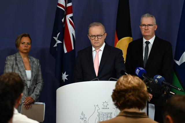 Australia's Prime Minister Anthony Albanese (C) speaks on the Royal Commission on last year's mass shooting incident where two gunmen killed 15 people at Australia's Bondi Beach, while Home Affairs Minister Tony Burke (R) and Attorney-General Michelle Rowland (L) look on during a press conference in Sydney on April 30, 2026. Australia should bolster security at Jewish events and review key counter-terrorism teams in the wake of last year's antisemitic mass shooting at Bondi Beach, a high-powered inquiry found on April 30. (Photo by Saeed KHAN / AFP)