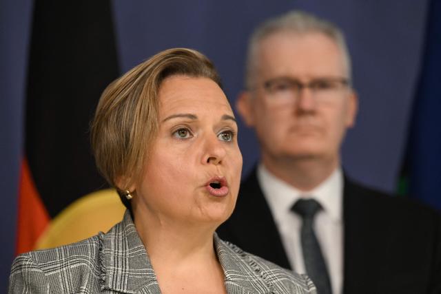 Australia's Attorney-General Michelle Rowland speaks on the Royal Commission on last year's mass shooting incident where two gunmen killed 15 people at Australia's Bondi Beach, while Home Affairs Minister Tony Burke (R) looks on during a press conference in Sydney on April 30, 2026. Australia should bolster security at Jewish events and review key counter-terrorism teams in the wake of last year's antisemitic mass shooting at Bondi Beach, a high-powered inquiry found on April 30. (Photo by Saeed KHAN / AFP)