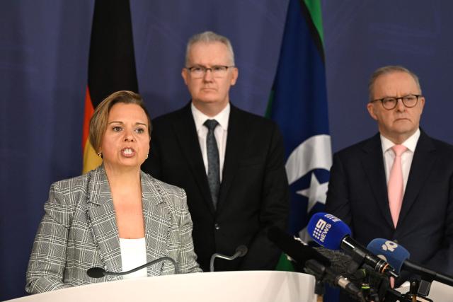 Australia's Attorney-General Michelle Rowland (L) speaks on the Royal Commission on last year's mass shooting incident where two gunmen killed 15 people at Australia's Bondi Beach, while Prime Minister Anthony Albanese (R) and Home Affairs Minister Tony Burke look on during a press conference in Sydney on April 30, 2026. Australia should bolster security at Jewish events and review key counter-terrorism teams in the wake of last year's antisemitic mass shooting at Bondi Beach, a high-powered inquiry found on April 30. (Photo by Saeed KHAN / AFP)