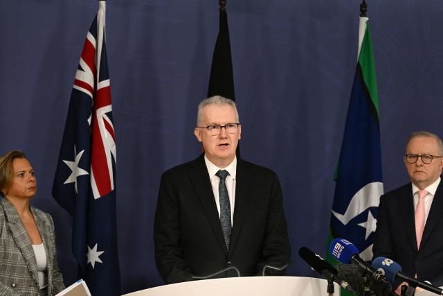 Australia's Home Affairs Minister Tony Burke (C) speaks on the Royal Commission on last year's mass shooting incident where two gunmen killed 15 people at Australia's Bondi Beach, while Prime Minister Anthony Albanese (R) and Attorney-General Michelle Rowland (L) look on during a press conference in Sydney on April 30, 2026. Australia should bolster security at Jewish events and review key counter-terrorism teams in the wake of last year's antisemitic mass shooting at Bondi Beach, a high-powered inquiry found on April 30. (Photo by Saeed KHAN / AFP)
