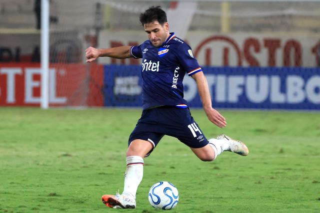 Nacional's midfielder #14 Nicolas Lodeiro kicks the ball during the Copa Libertadores group stage football match between Peru's Universitario and Uruguay's Nacional at the Monumental "U" Marathon stadium in Lima on April 29, 2026. (Photo by Connie FRANCE / AFP)