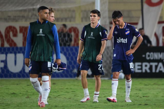 Nacional's forward #19 Juan Cruz de los Santos, midfielder #06 Luciano Boggio, Argentine forward #27 Tomas Veron and midfielder #10 Alexander dos Santos react after losing the Copa Libertadores group stage football match between Peru's Universitario and Uruguay's Nacional at the Monumental "U" Marathon stadium in Lima on April 29, 2026. (Photo by Connie FRANCE / AFP)