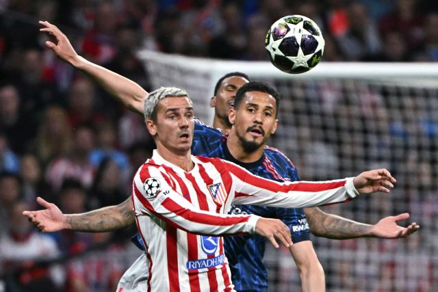 TOPSHOT - Arsenal's Brazilian defender #06 Gabriel Magalhaes challenges Atletico Madrid's French forward #07 Antoine Griezmann during the UEFA Champions League semi-final first leg football match between Club Atletico de Madrid and Arsenal at the Metropolitano stadium in Madrid on April 29, 2026. (Photo by Javier SORIANO / AFP)