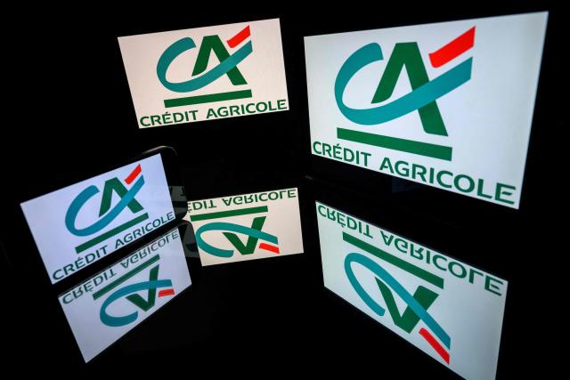 (FILES) This photograph shows screens displaying the logo of the company Credit Agricole, listed on the CAC 40, the main stock market index of the Paris Stock Exchange, in Toulouse on March 31, 2026. The French banking group Credit Agricole reported on April 30, 2026 a rise in net profit for the first quarter of 2026, although it had to increase its provisions to address heightened economic risks linked to the war in the Middle East. (Photo by Lionel BONAVENTURE / AFP)