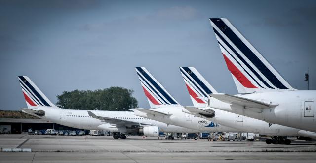 (FILES) French airliner company Air France's planes are parked on April 24, 2018 on the tarmac of the Roissy-Charles de Gaulle airport near Paris as company staff stage a second consecutive day of strikes calling for a pay rise. The Franco-Dutch aviation giant Air France-KLM lowered its forecasts for 2026 on April 30, 2026 due to the war in the Middle East, anticipating slower growth as fuel costs are set to soar. (Photo by STEPHANE DE SAKUTIN / AFP)
