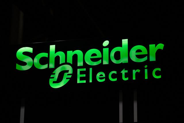 (FILES) This photo shows a neon sign at a Schneider Electric production sitet in Macon, central-eastern France, on February 16, 2026. Schneider Electric on April 30, 2026, announced a record quarterly turnover of Ђ9.8 billion, driven by data centres. (Photo by ARNAUD FINISTRE / AFP)