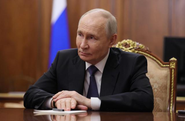 In this pool photograph distributed by the Russian state agency Sputnik, Russia's President Vladimir Putin looks on as he meets with Chechen leader at the Kremlin in Moscow late on April 29, 2026. (Photo by Mikhail METZEL / POOL / AFP) / Editor's note : this image is distributed by the Russian state owned agency Sputnik
