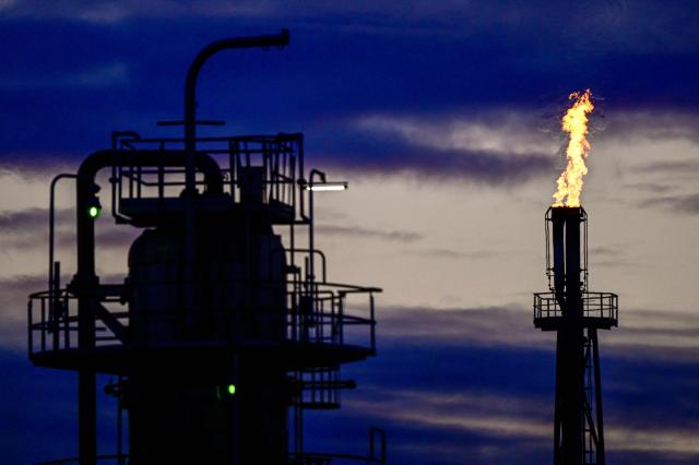 A flame comes out of one of the chimneys of the PCK Schwedt refinery in Schwedt, northeastern Germany, are pictured  at the company's plant on early April 30, 2026, one day before Russia will halt the pipeline flow of Kazakh oil to Germany, citing technical reasons. The stoppage from May 1, 2026 will impact the PCK refinery, run by the German subsidiary of Russia's state-owned oil company Rosneft, that supplies much of the Berlin region and the capital's international airport with fuel. The move by Moscow comes amid Russia's war against Ukraine and a global energy crisis sparked by the US-Israeli war against Iran, which has caused major disruptions to global oil and gas markets. The German government stressed it does not expect an energy supply crunch. (Photo by Tobias SCHWARZ / AFP)
