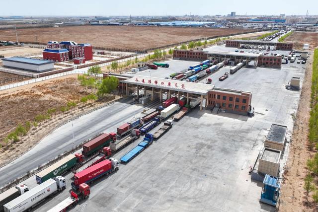 Trucks wait to clear customs at the Erenhot Highway Port Logistics Park, the largest land port on the border between China and Mongolia, in Erenhot in China’s northern Inner Mongolia region on April 30, 2026. (Photo by CN-STR / AFP) / China OUT