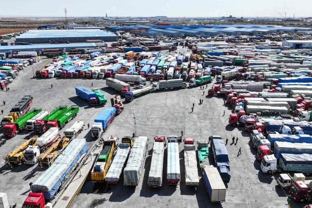 Trucks wait to clear customs at the Erenhot Highway Port Logistics Park, the largest land port on the border between China and Mongolia, in Erenhot in China’s northern Inner Mongolia region on April 30, 2026. (Photo by CN-STR / AFP) / China OUT