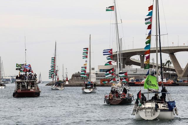 (FILES) Boats of a new humanitarian flotilla bound for the Gaza Strip make a symbolic leave from Barcelona's Port Vell on April 12, 2026 as the departure of the flotilla has been postponed due to bad weather. Israel's army arrested around 175 activists from a Gaza-bound aid flotilla in international waters off Greece, the Israeli foreign ministry and the flotilla's organisers said on April 30, 2026. The organisers of the latest flotilla of pro-Palestinian activists seeking to break Israel's blockade on Gaza had announced shortly beforehand that their boats were surrounded by Israeli military ships while off the coast of the Greek island of Crete. (Photo by Josep LAGO / AFP)