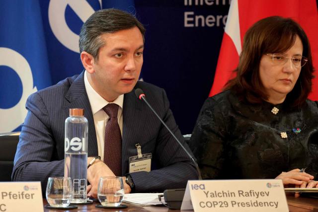COP29 Chief Negotiator and Azerbaijan's Deputy Minister of Foreign Affairs Yalchin Rafiyev (L) speaks as he takes part in a conference on energy transition ahead of the 2026 United Nations conference on climate change COP31 at the IEA (International Energy Agency) in Paris on April 30, 2026. (Photo by Ludovic MARIN / AFP)