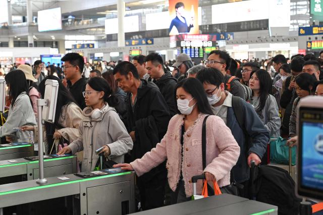 Passengers prepare to board trains at Shanghai Hongqiao Railway Station in Shanghai on April 30, 2026, ahead of the Labour Day holiday which starts on May 1. (Photo by JADE GAO / AFP)