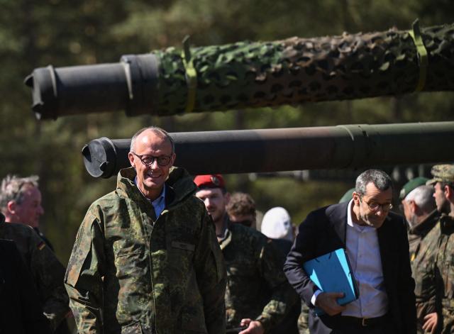 German Chancellor Friedrich Merz smiles as he walks in the compound of the German army barracks in Munster, northern Germany, on April 30, 2026, as they visit the troops of the German Army. (Photo by Daniel Reinhardt / AFP)