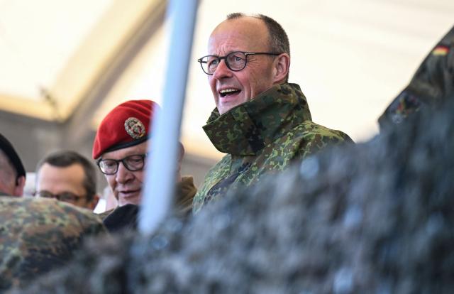 German Chancellor Friedrich Merz (R) looks on as he visits the troops of the German Army at the German army barracks in Munster, northern Germany, on April 30, 2026. (Photo by Daniel Reinhardt / AFP)