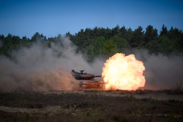 A Leopard 2A6 tank fires during a demonstration for the German Chancellor visiting the troops of the German Army (Bundeswehr) at the German armed forces' barracks in Munster, northern Germany, on April 30, 2026. (Photo by DANIEL REINHARDT / AFP)