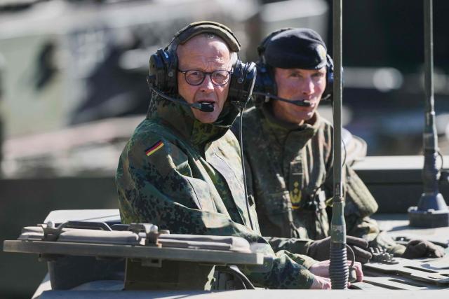 German Chancellor Friedrich Merz (L) and the Inspector of the Army Christian Freuding are sitting in a GTK Boxer tank at the German army barracks in Munster, northern Germany, on April 30, 2026, as they visit the troops of the German Army. (Photo by Markus Schreiber / POOL / AFP)