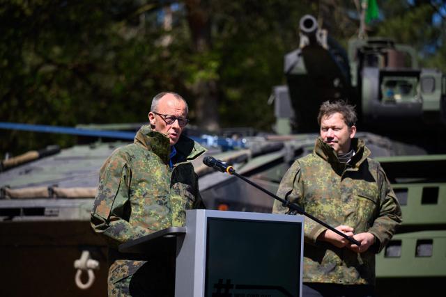 German Chancellor Friedrich Merz (L) addresses journalists nect to German Finance Minister and Vice Chancellor Lars Klingbeil during their visit to the German army barracks in Munster, northern Germany, on April 30, 2026. (Photo by DANIEL REINHARDT / AFP)