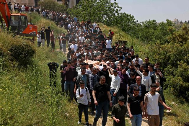Mourners carry the body of 16-year-old Palestinian Ibraheem Khayyat, who was killed in an Israeli raid, during his funeral in the occupied West Bank city of Hebron on April 30, 2026. (Photo by HAZEM BADER / AFP)