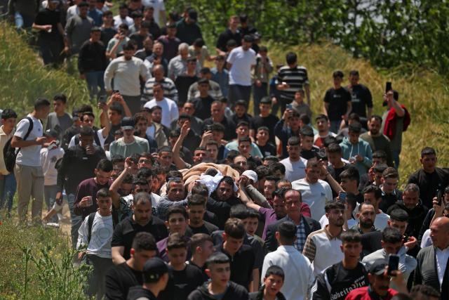 Mourners carry the body of 16-year-old Palestinian Ibraheem Khayyat, who was killed in an Israeli raid, during his funeral in the occupied West Bank city of Hebron on April 30, 2026. (Photo by HAZEM BADER / AFP)