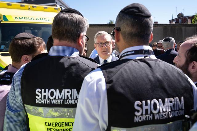 Britain's Prime Minister Keir Starmer (C) meets first responders from Shomrim North West London during a visit to Golders Green in north-west London on April 30, 2026, the day after two men were stabbed. Two Jewish men were wounded in stabbings in north London on April 29, investigated by police in the British capital as a "terrorist incident", after a series of antisemitic attacks in recent weeks. (Photo by Stefan Rousseau / POOL / AFP)